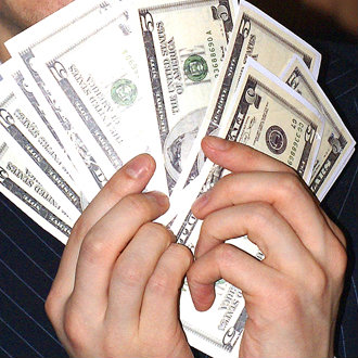 holding pile of money